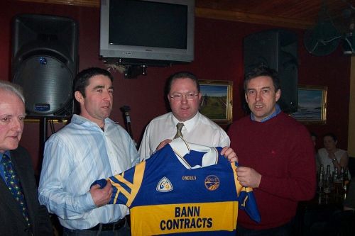 Brian Fox (right) presents Club Chairman John Robinson (center right)
and Senior Team Captain Eamon Toye (center left) with a new team kit.