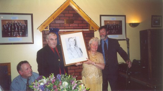 Joe Nugent presents Minnie Hamill with a portrait of her late husband, Felix.