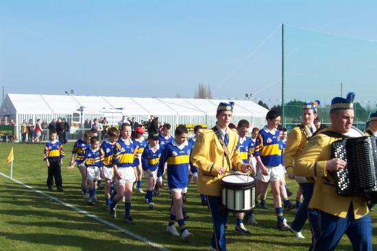 St. John's Band, Portadown lead Maghery youth players in a parade before the game.