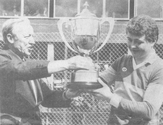 Victorious captain Kevin Rafferty receives the Frank Hanna Memorial Trophy from Football Board Chairman Pat McMahon